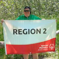 Roy Stephens holding the Region 2 banner