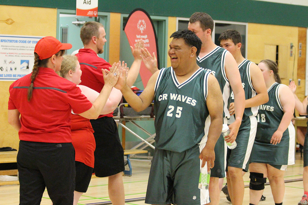 Special Olympics BC basketball athletes congratulate the opposing team after their game.