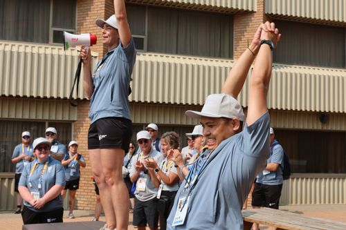 Smiling members of Special Olympics Team BC cheering