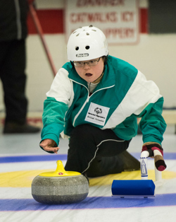 A Special Olympics BC athlete throwing a curling rock.