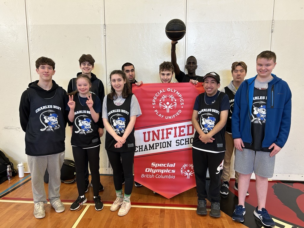 Students stand with a Unified Champion School banner.