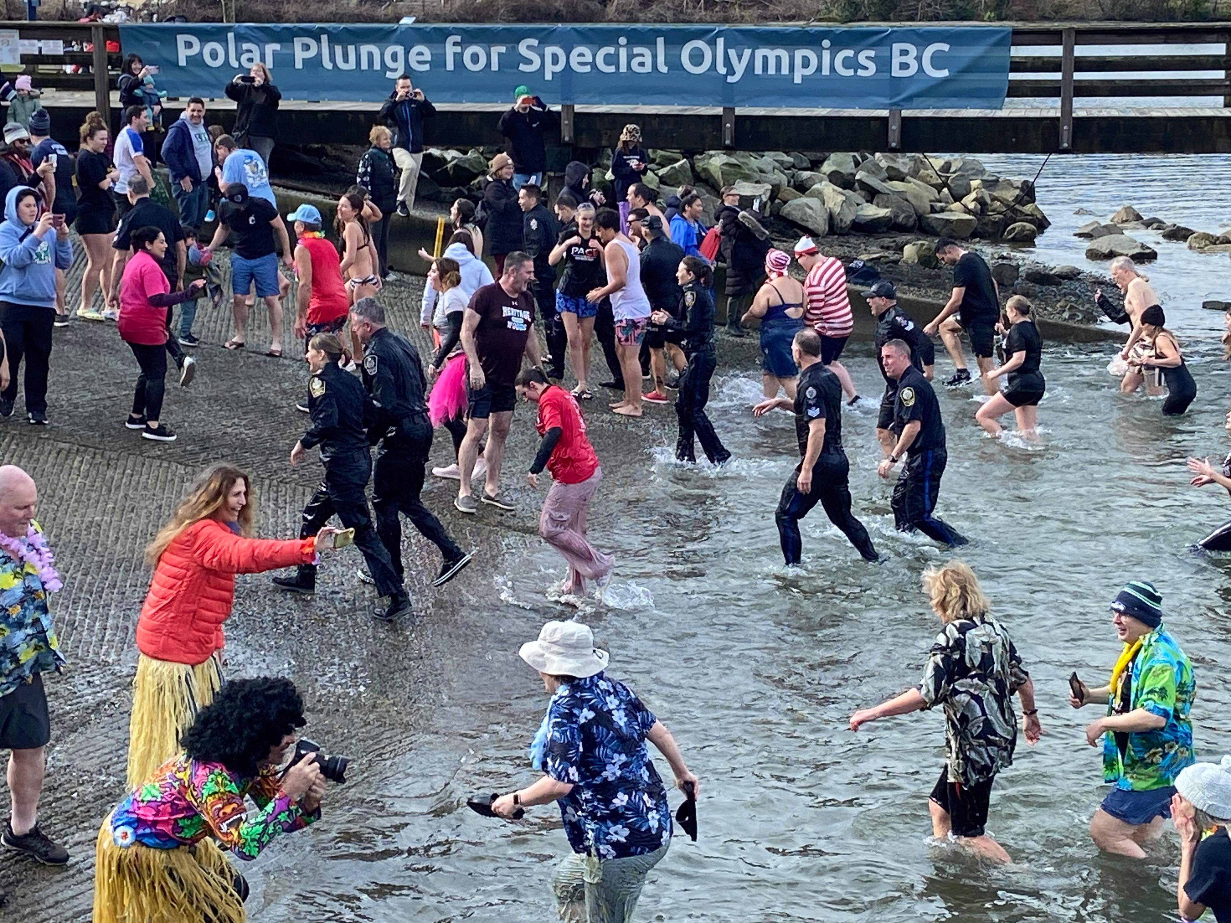 Law Enforcement Torch Run Polar Plunge for Special Olympics BC participants wade out of the waters of Burrard Inlet. Law Enforcement Torch Run Polar Plunge for Special Olympics BC participants wade out of the waters of Burrard Inlet.