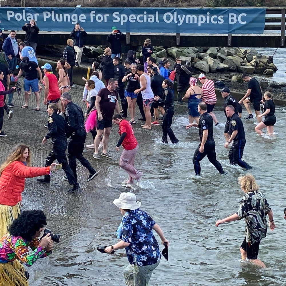 Law Enforcement Torch Run Polar Plunge for Special Olympics BC participants wade out of the waters of Burrard Inlet.
