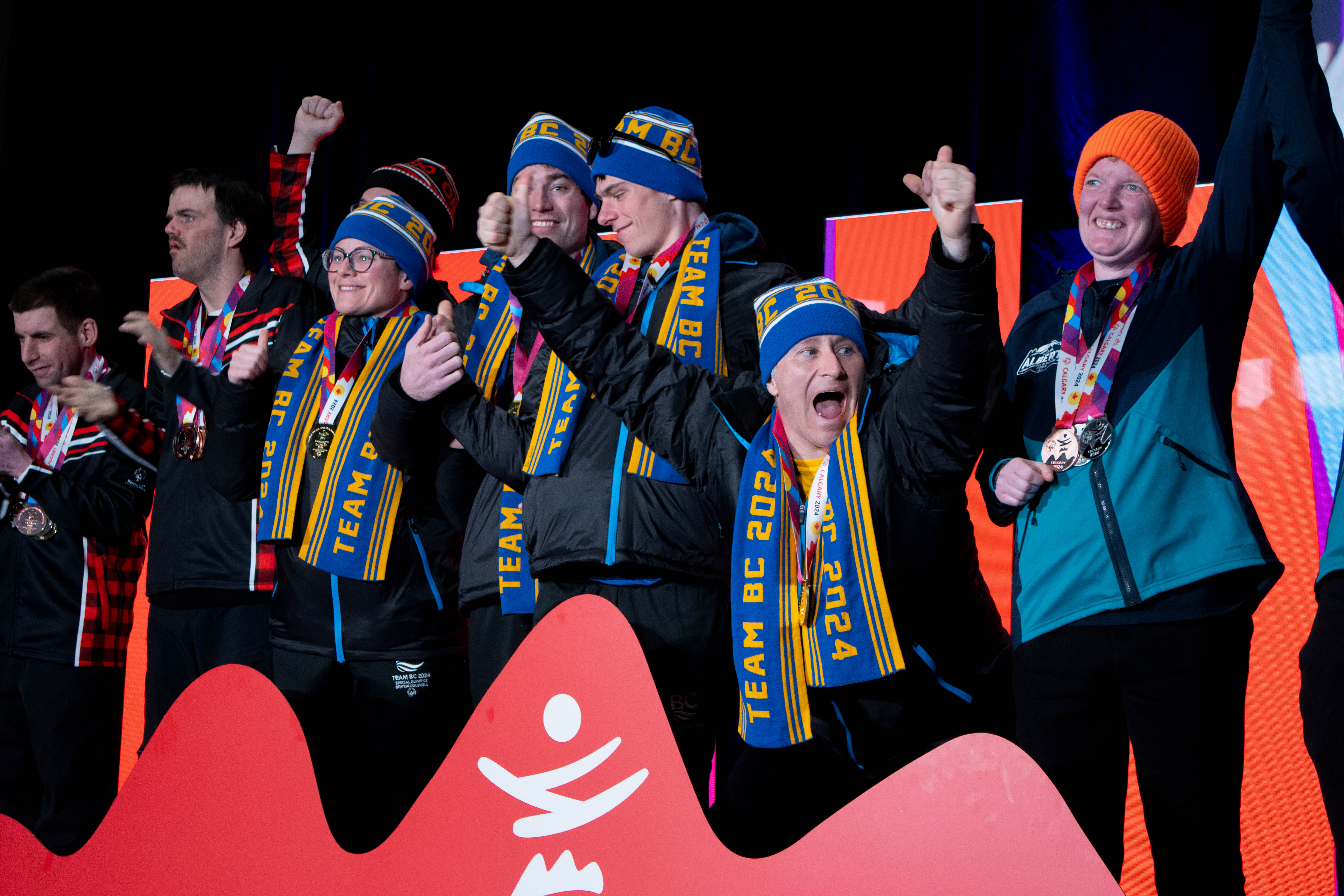 A group of Special Olympics BC athletes show excitement and joy as they receive their medals at the 2024 Special Olympics Canada National Winter Games in Calgary.