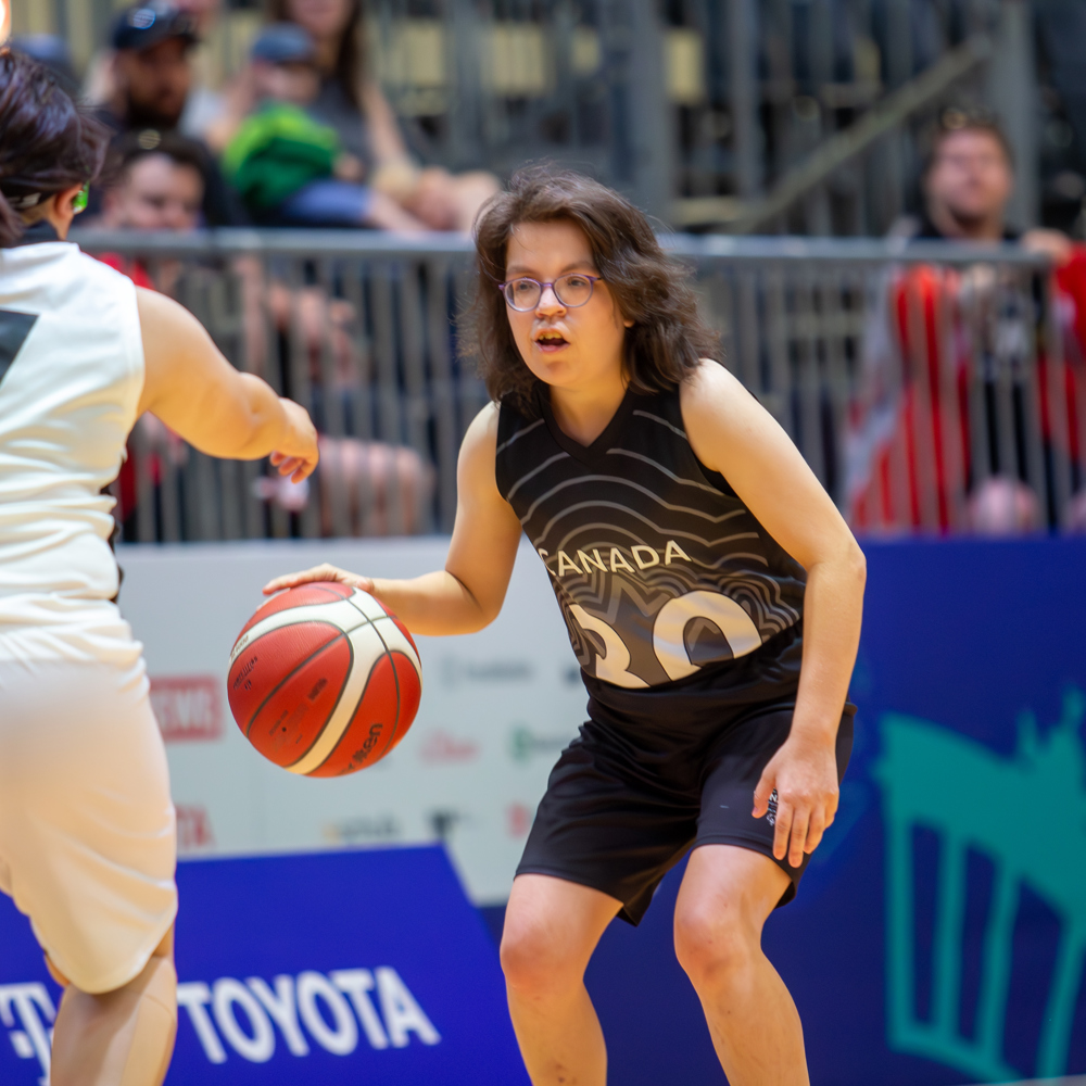 A determined Special Olympics BC athlete approaches her opponent on the court during the 2023 Special Olympics World Games.