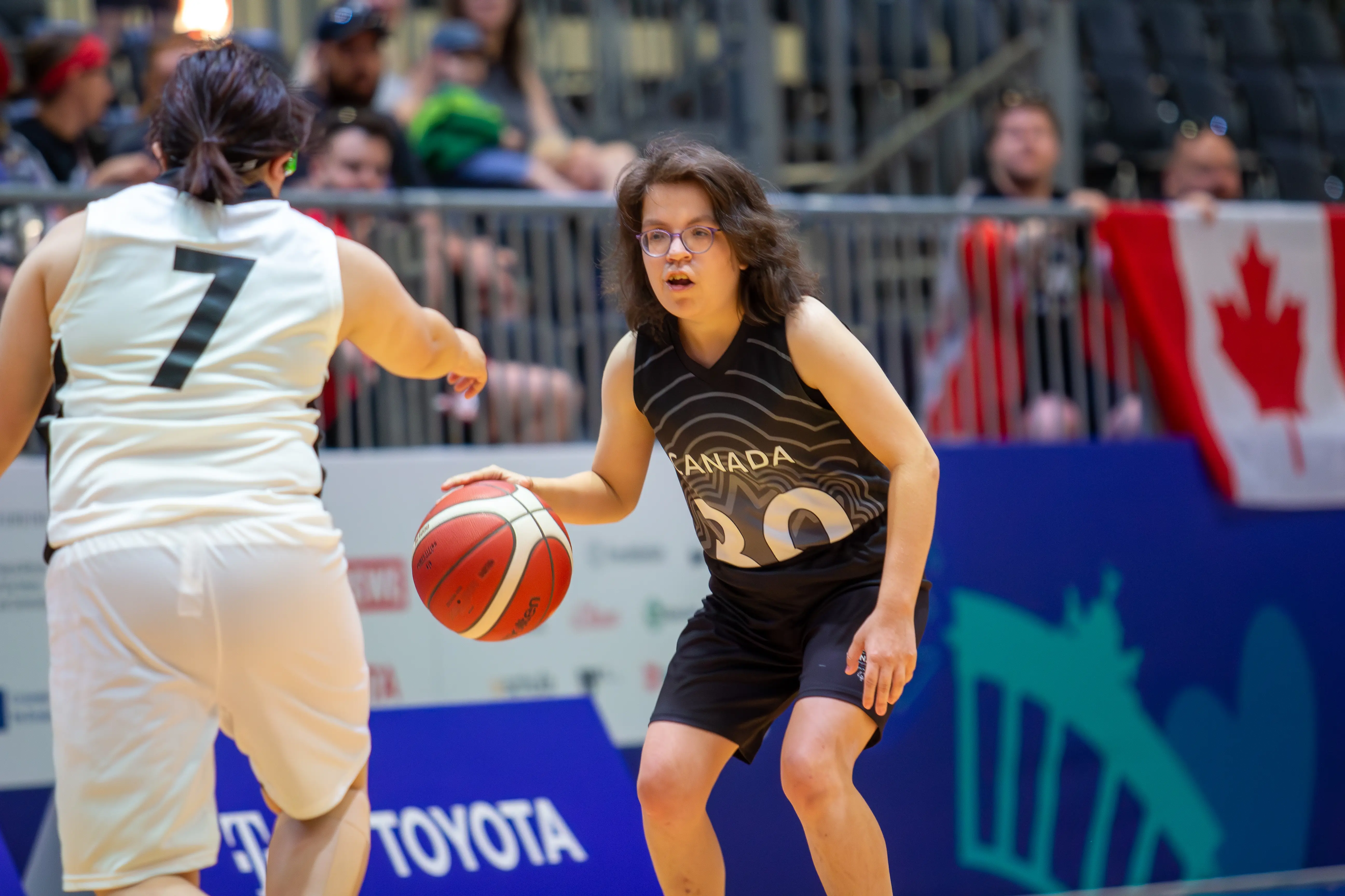 A determined Special Olympics BC athlete approaches her opponent on the court during the 2023 Special Olympics World Games. A determined Special Olympics BC athlete approaches her opponent on the court during the 2023 Special Olympics World Games.