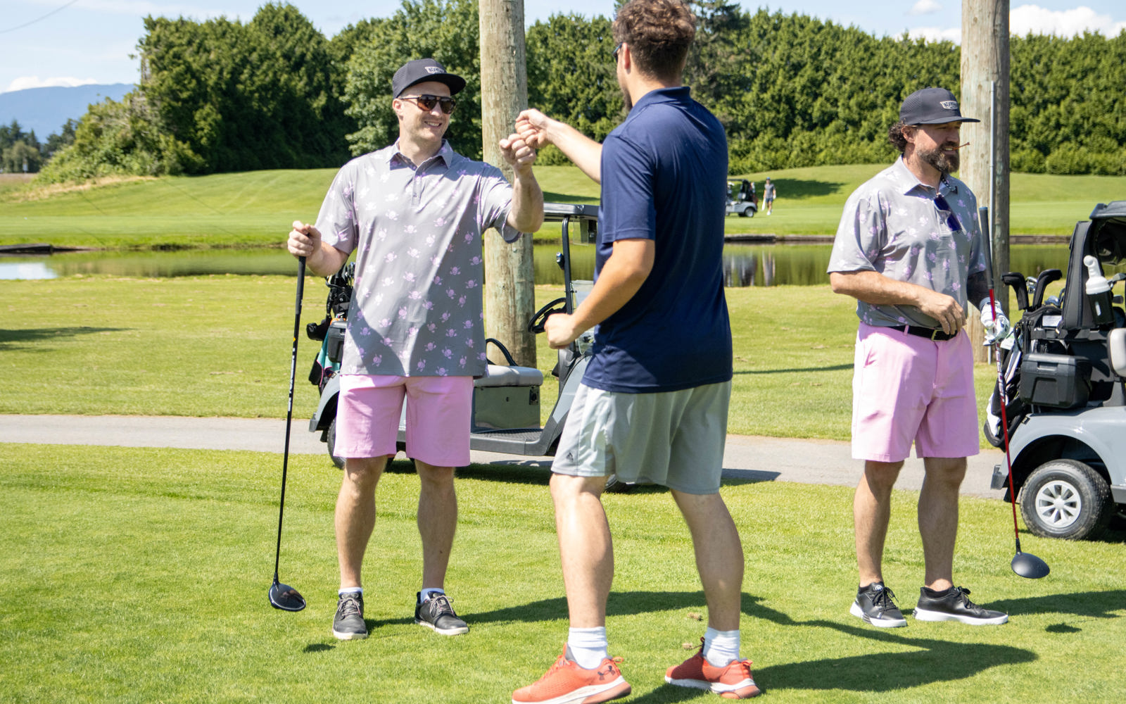 SOBC athlete gives a fist bump to a player on the greens.